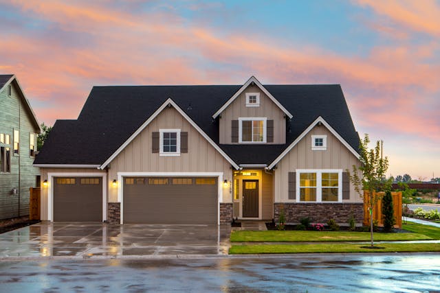 Brown and gray house, wet ground. Image by Pexels