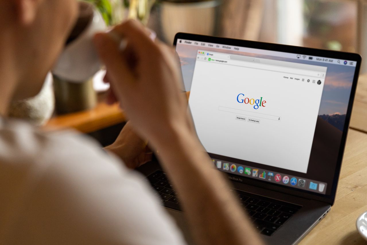 Person using a MacBook and drinking coffee. Image by Pexels