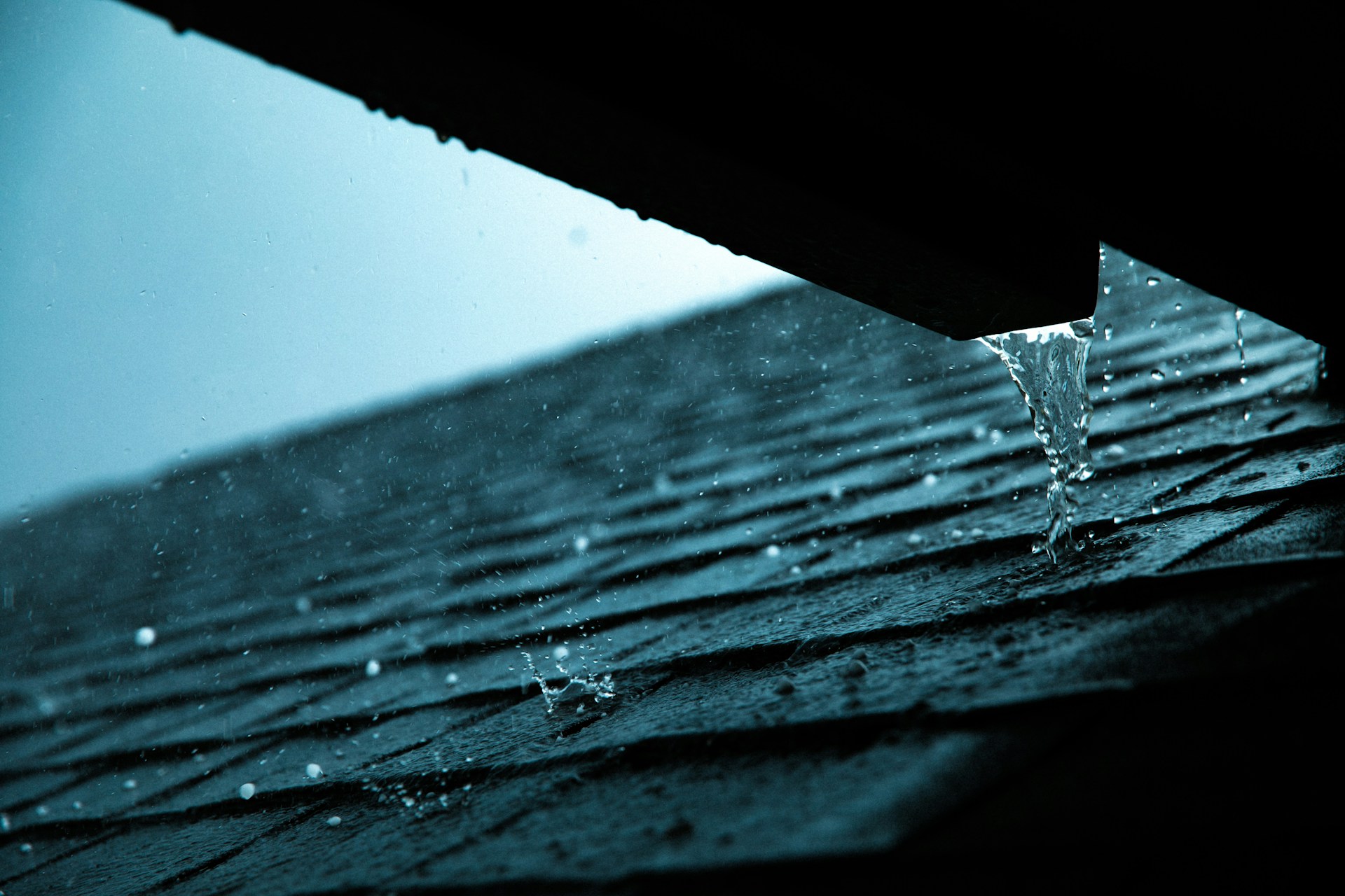 Close-up of a rain gutter on a roof showing potential water damage warning signs. Imgage by Unsplash