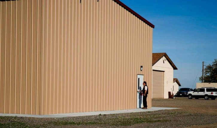 Person going into a large storage building