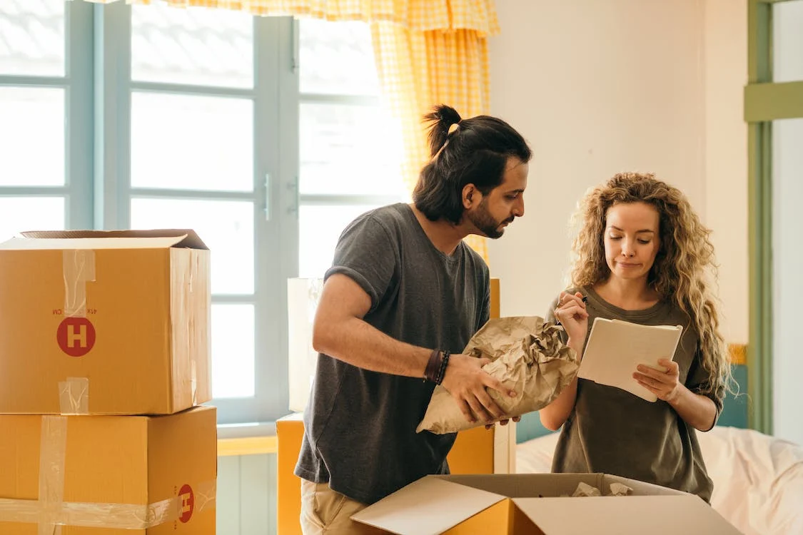Couple packing boxes before moving out of a rental property