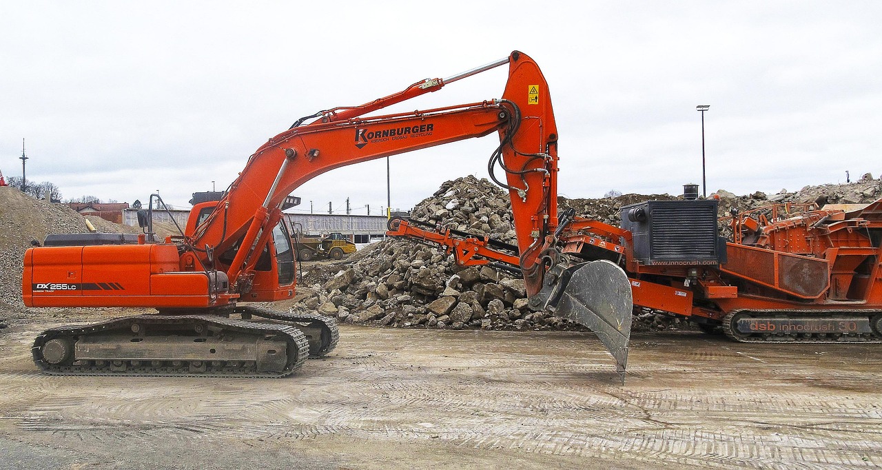 A rubble crusher and excavator at a demolition site