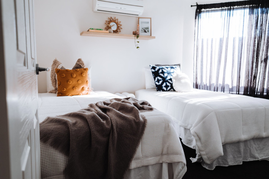 Two beds in bedroom in sunlight