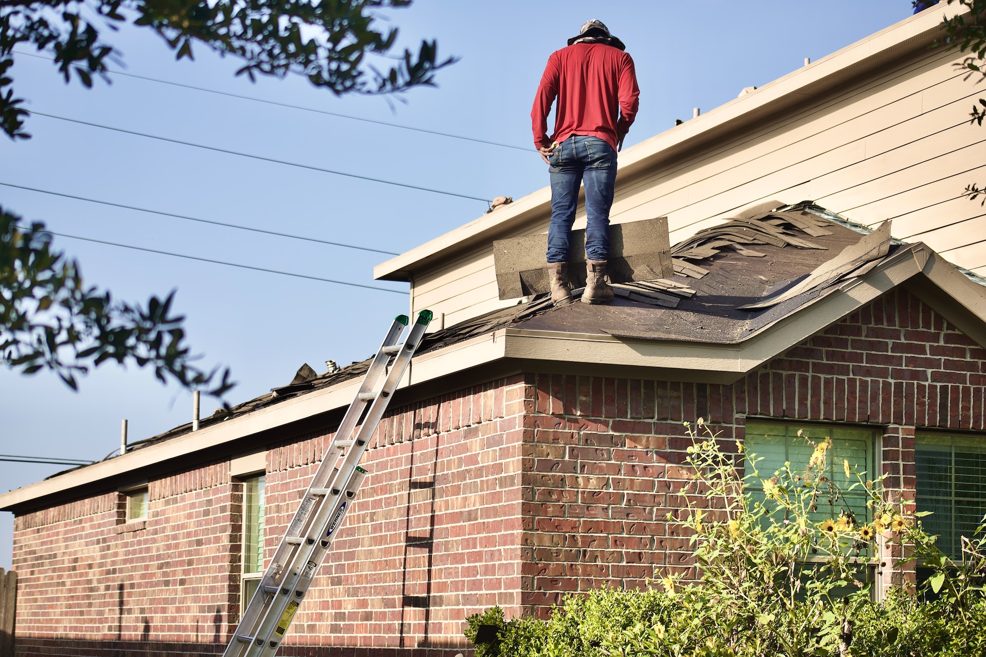 person on a roof, loose roof shingles