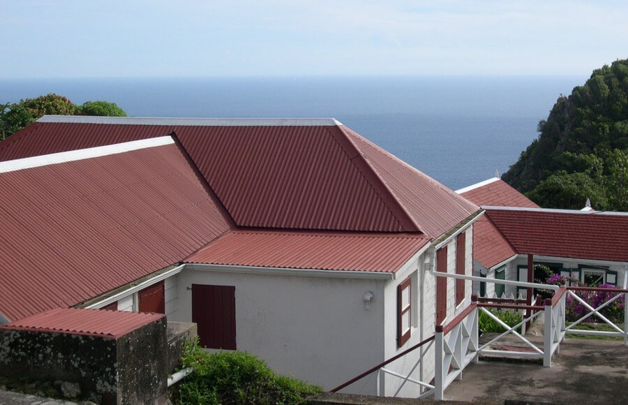 White house with red roof near an ocean