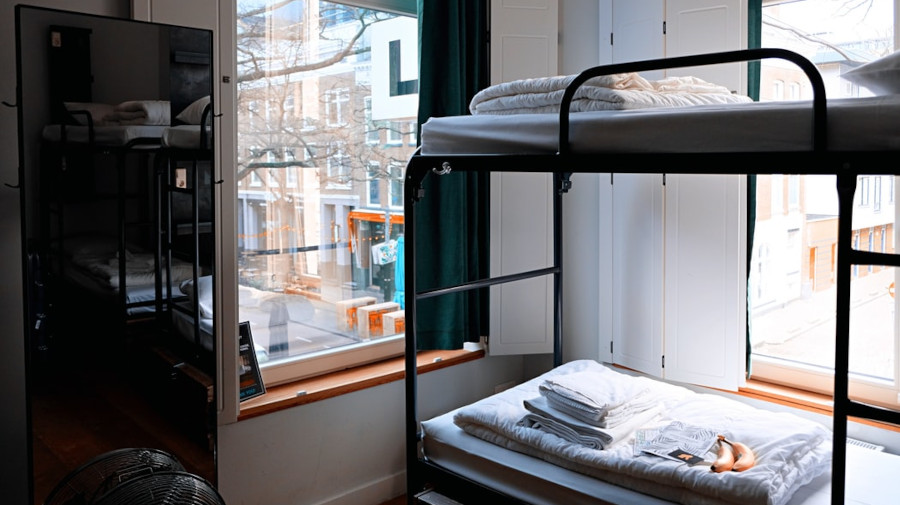 Bunkbed in a room with 2 large windows