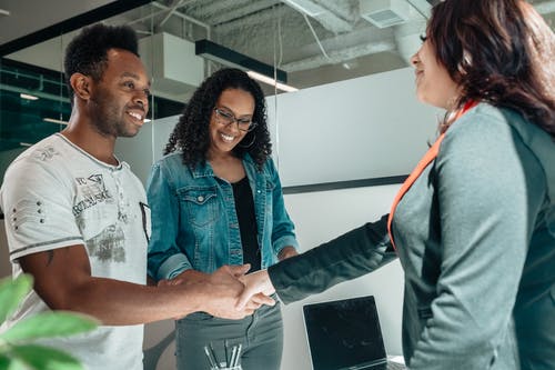 three people shaking hand