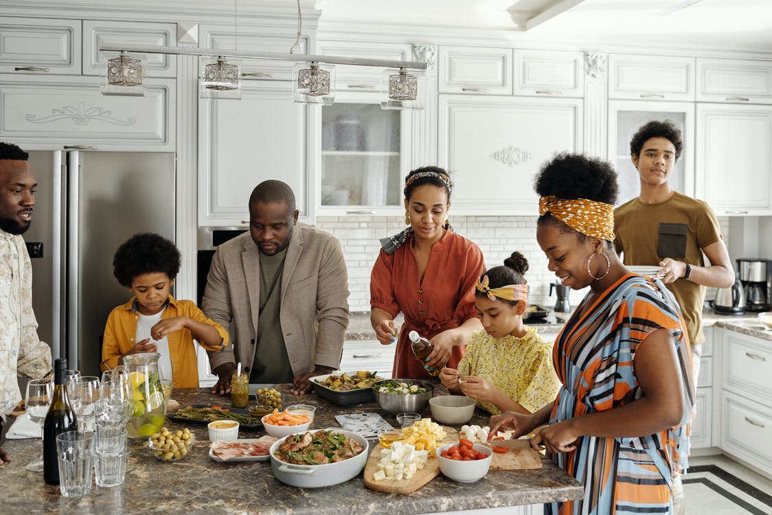 family gathering aroudn food in the kitchen