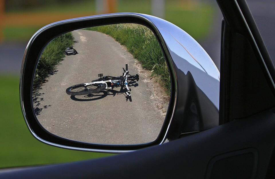 Seeing a bicycle on the ground from a car side mirror
