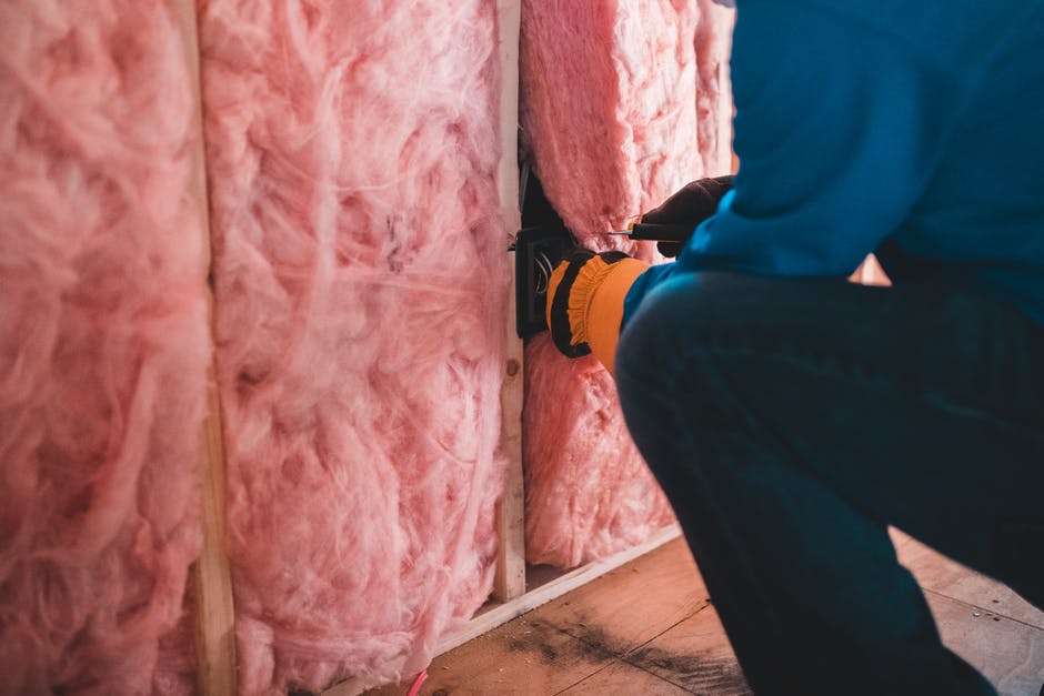 worker putting in insulation