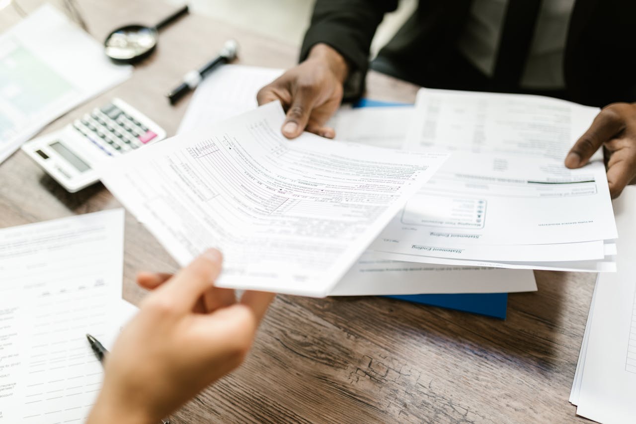 Person handing out documents. Image by Pexels