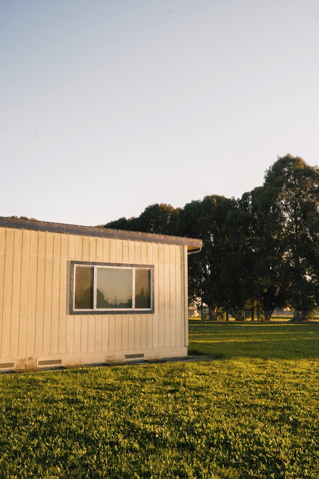 white and brown  house near trees. Image by Unsplash