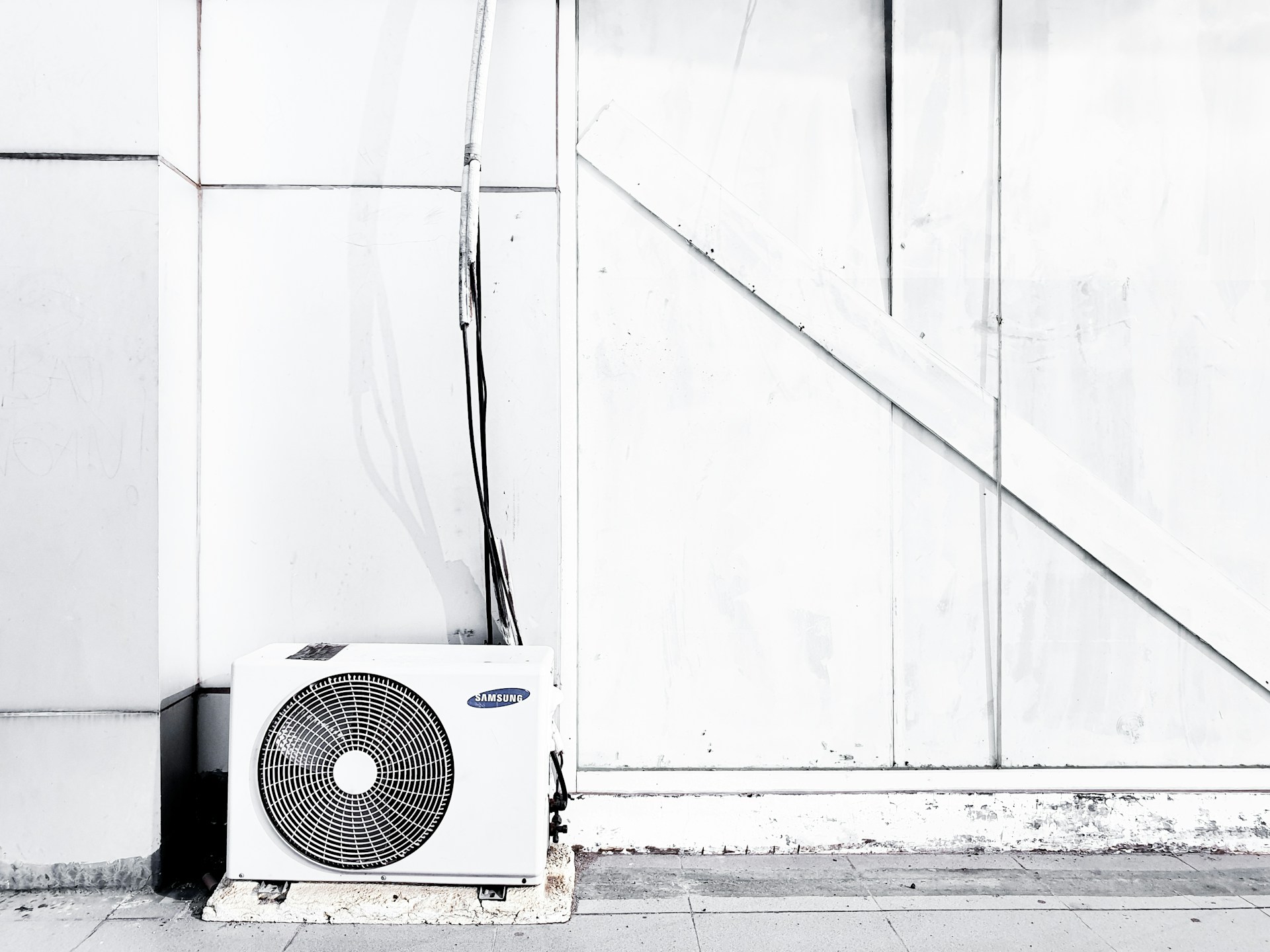 A/C, air conditioning unit outside a building. Image by Unsplash