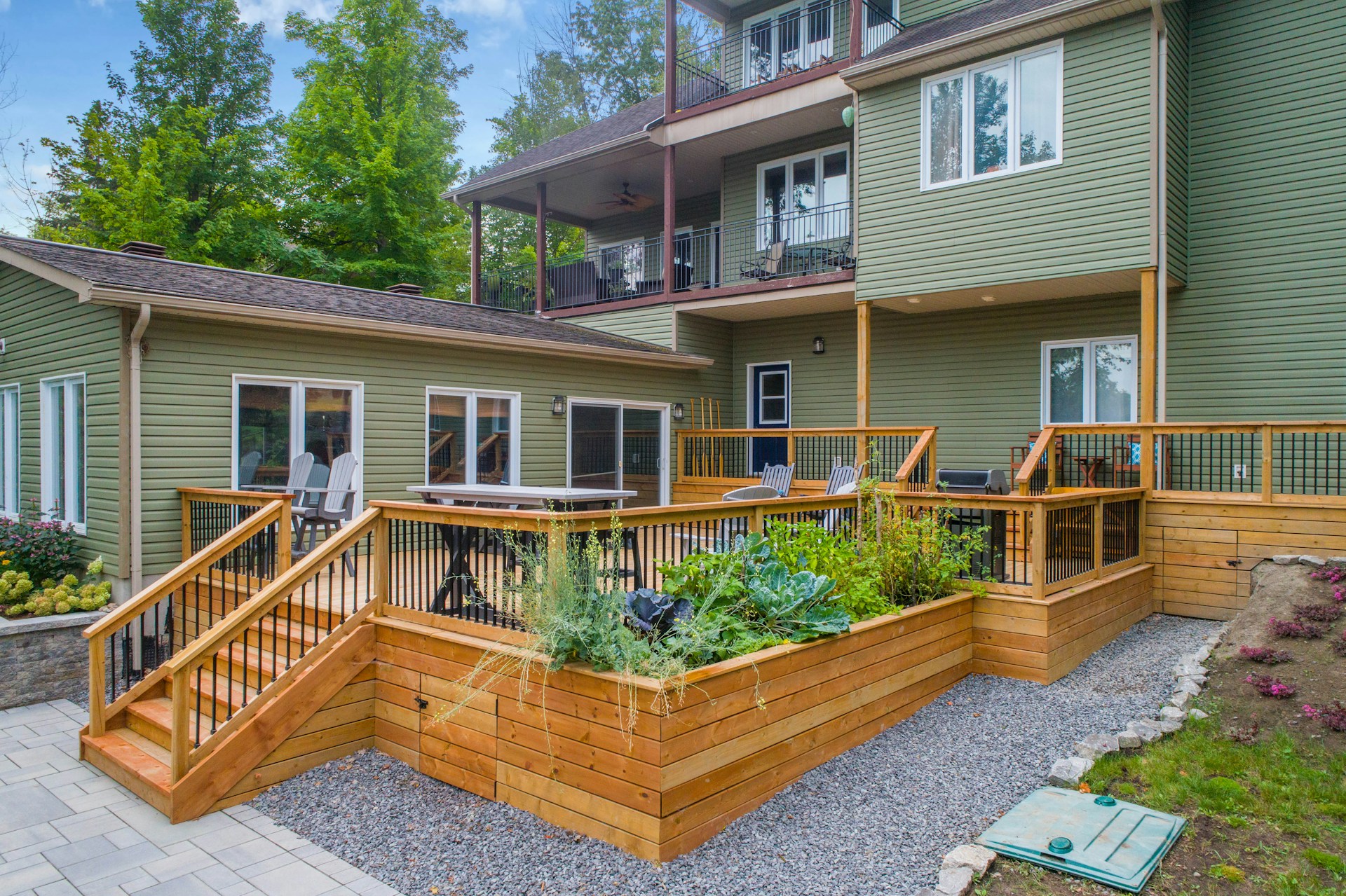 Green house with a large deck. Image by Unsplash