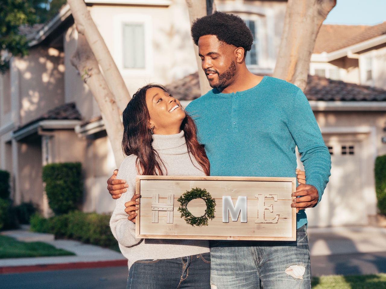 Man in blue crew neck long sleeve shirt holding brown wooden home decoration. Image by Pexels