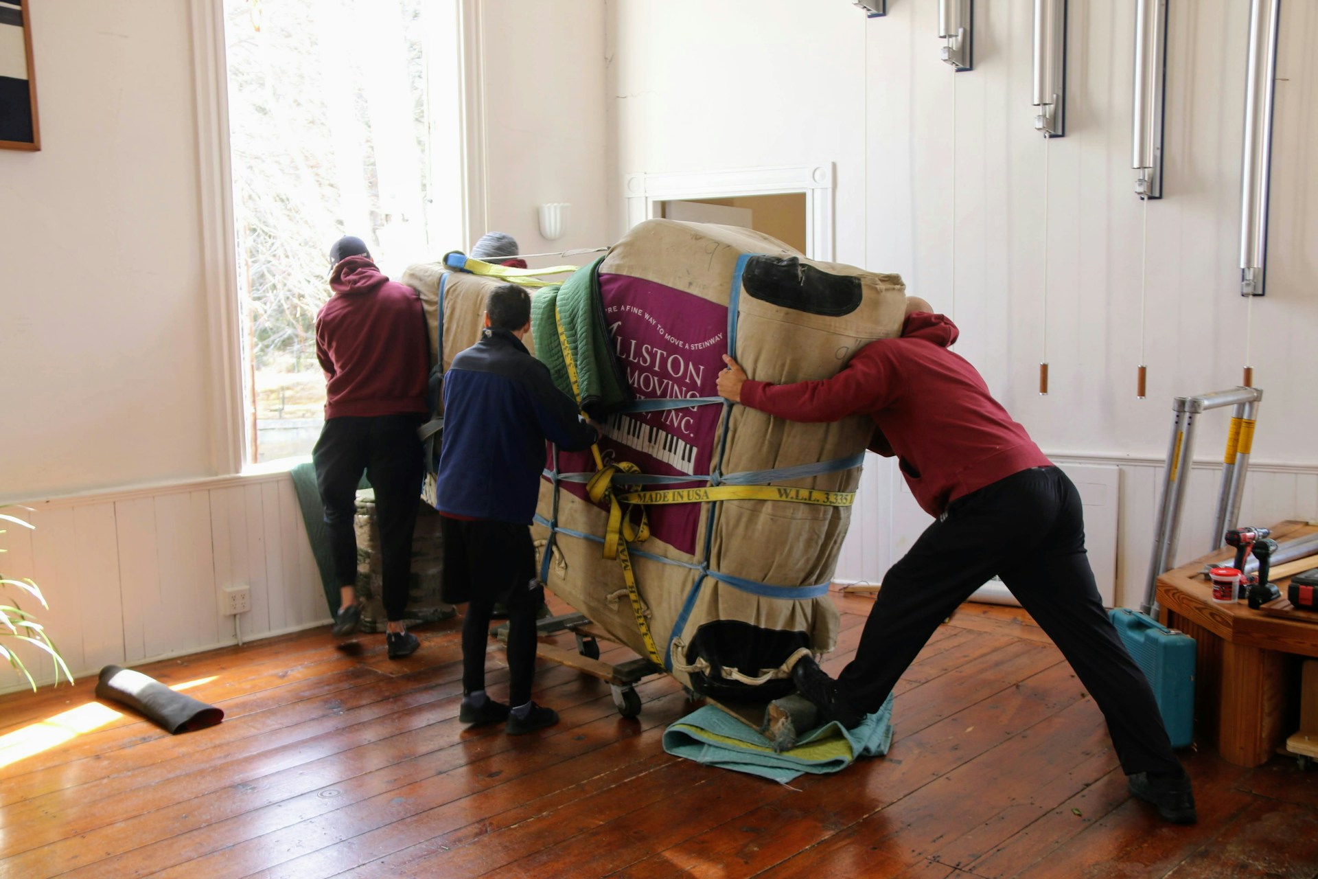 Group of movers loading furniture into a small self storage unit. Image via Unsplash