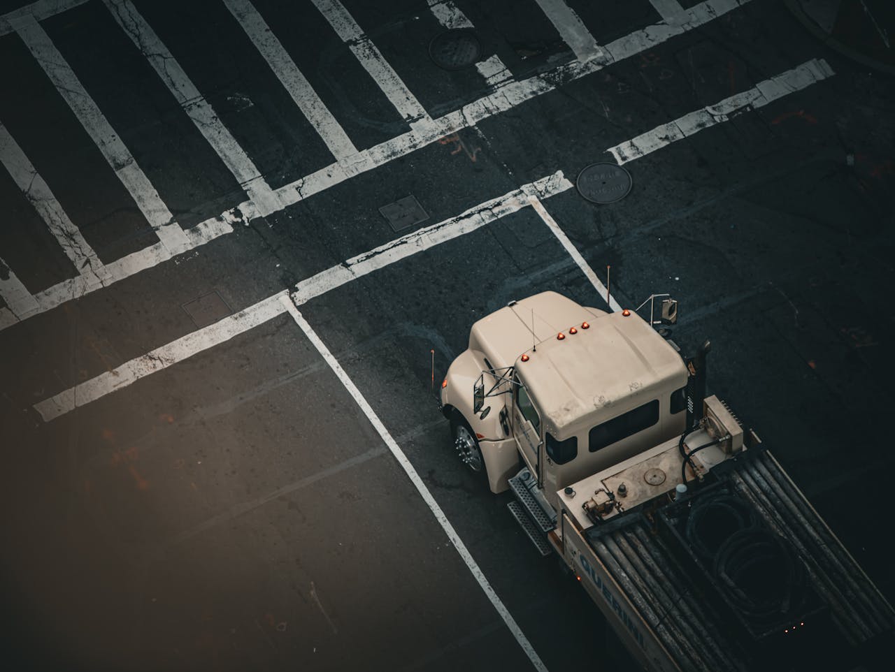Moving truck on a Boston street with historic brownstone buildings in the background. Photo by Bastian Riccardi on Pexels