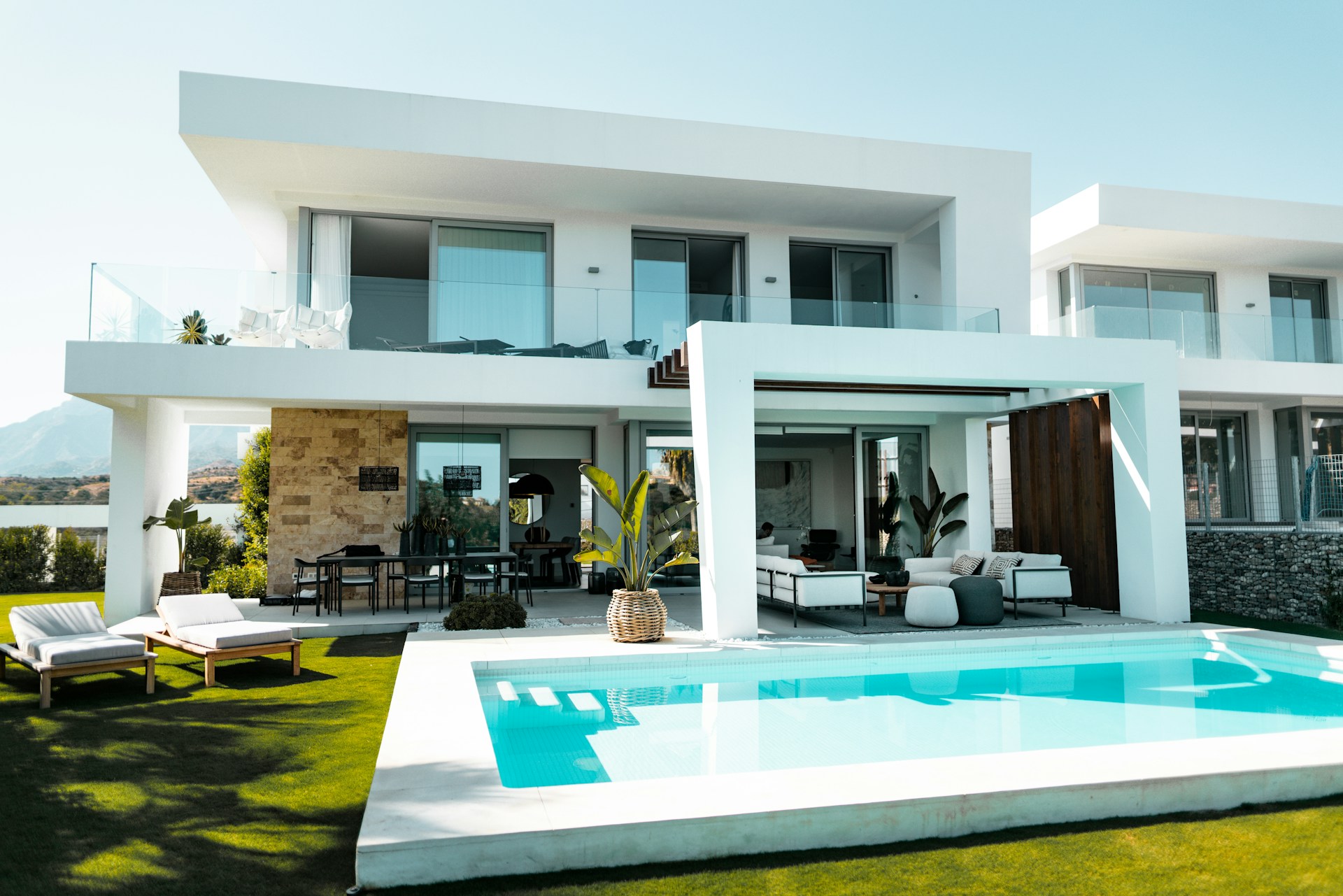 Large white concrete  house with a pool