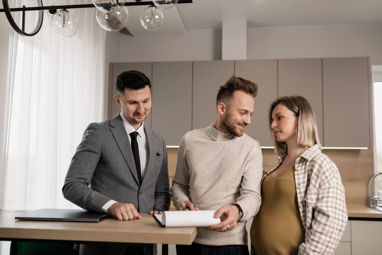 A family reviewing inheritance paperwork together at a kitchen table. Photo by Alena Darmel on Pexels
