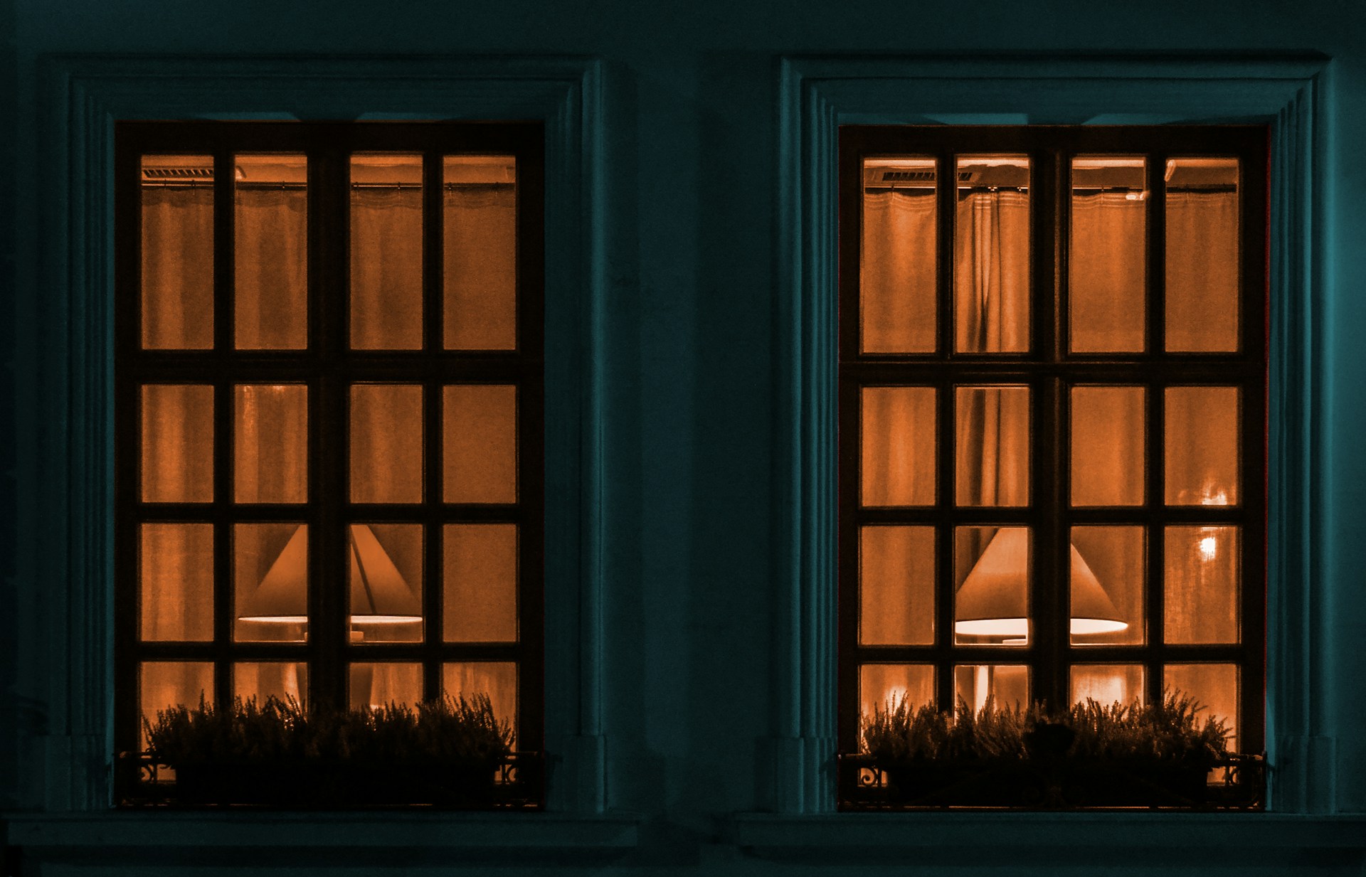 Glass window with a black panel showing high-performance security glass installation on a modern property. Image via Unsplash