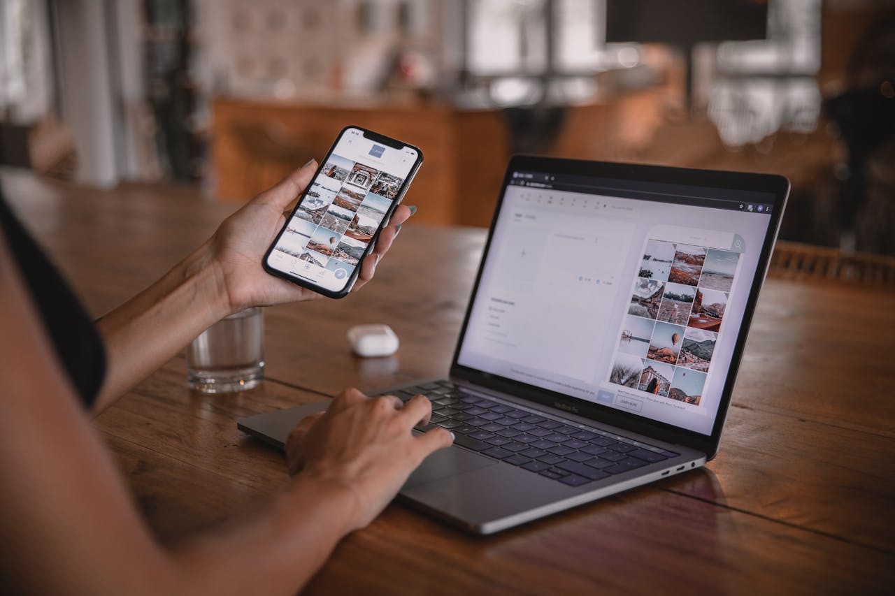 Person using a cellphone and a laptop. Image by Pexels