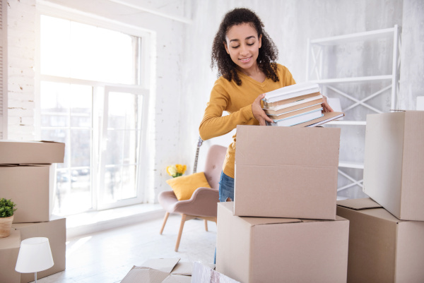 person unpacking boxes