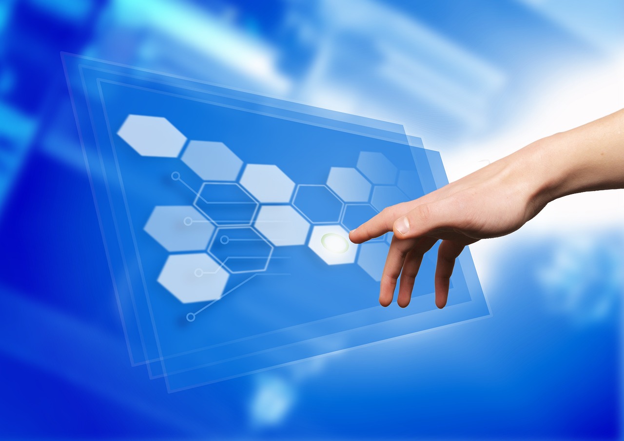 Hand tapping a digital touchscreen monitor. Image by Pixabay