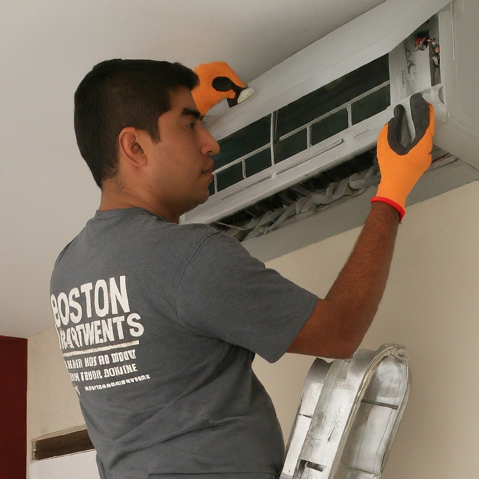person repairing an air conditioner. Image by Gemini