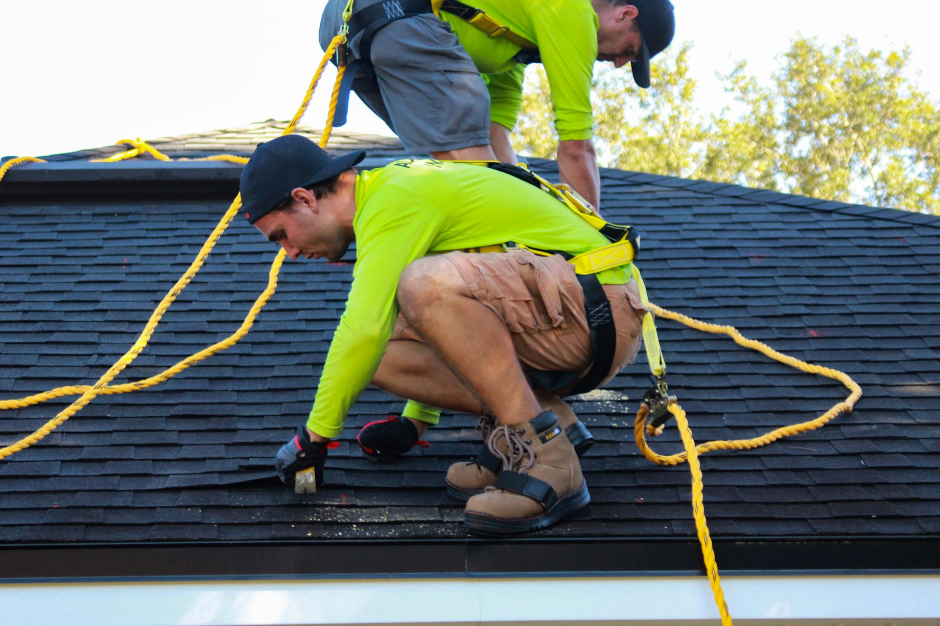 2 people working on a roof