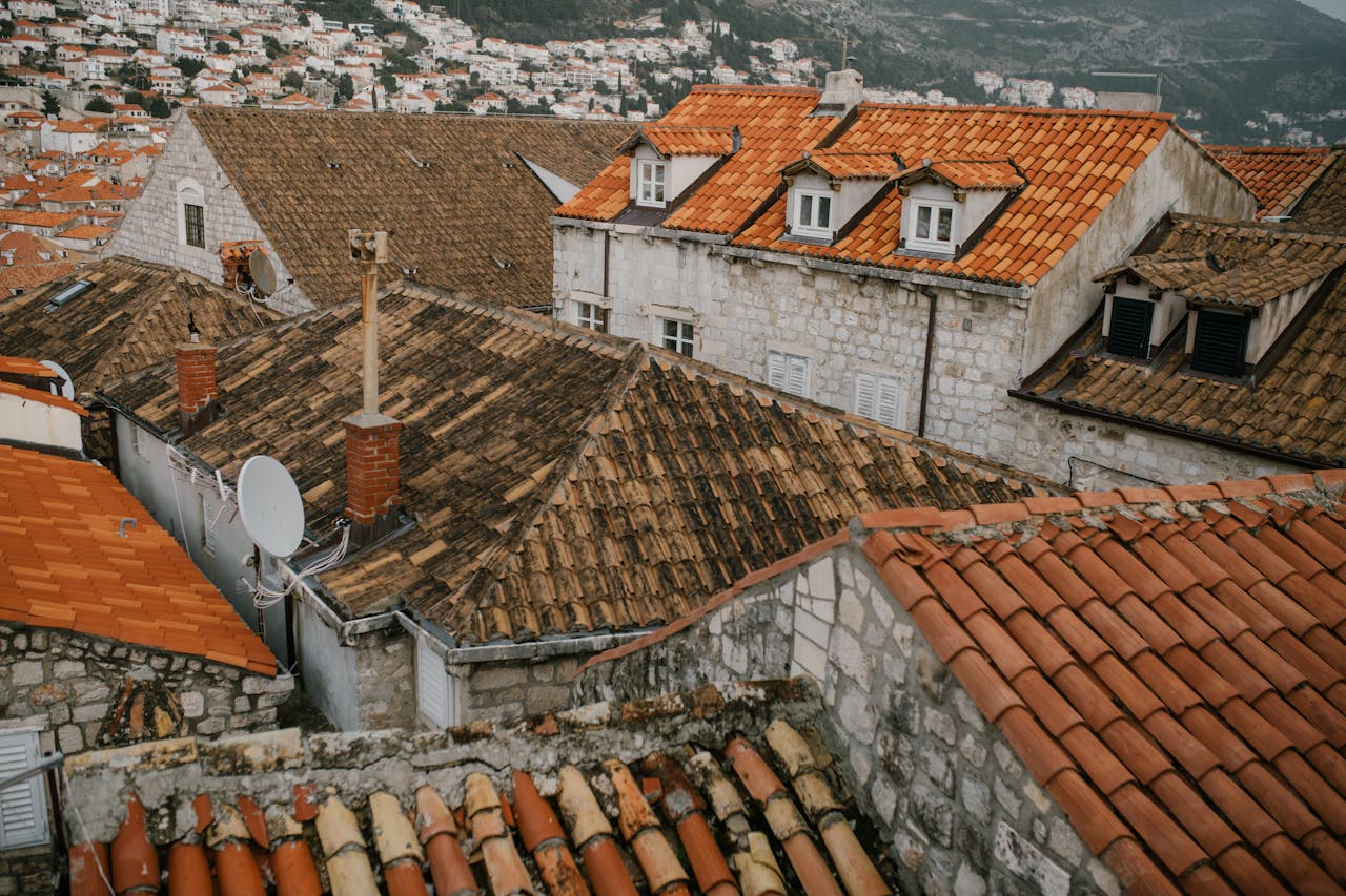 Old tiled roof of dwell buildings. Image by Pexels