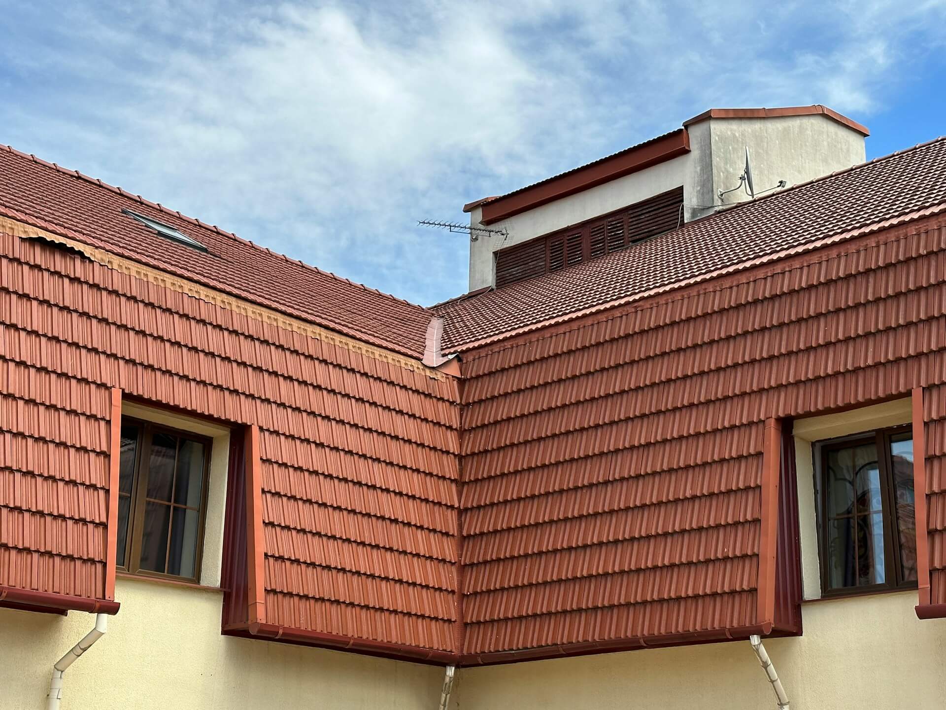 Red roof with two windows. Image by Unsplash