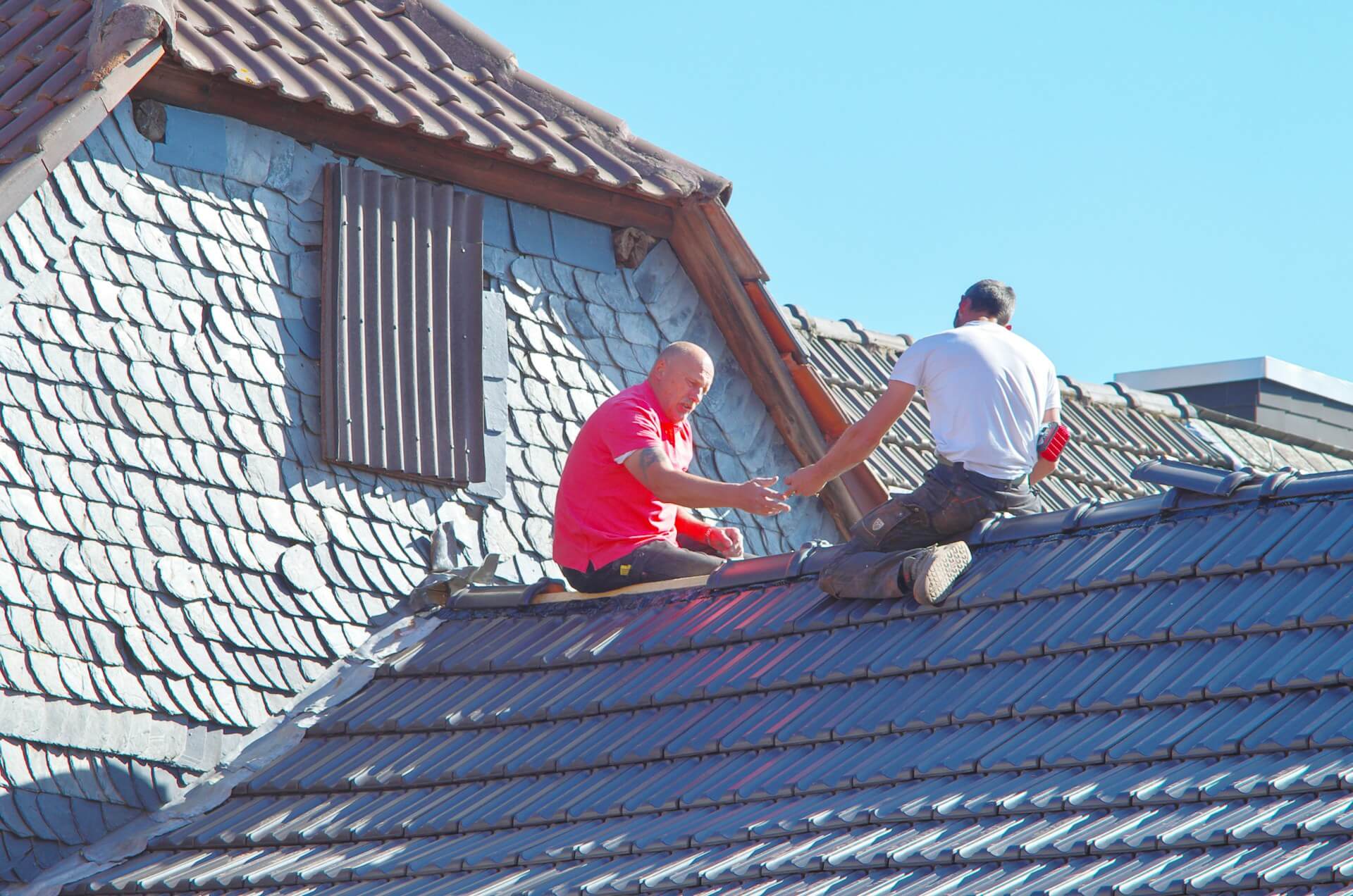 2 people working on a rooftop. Image by Unsplash