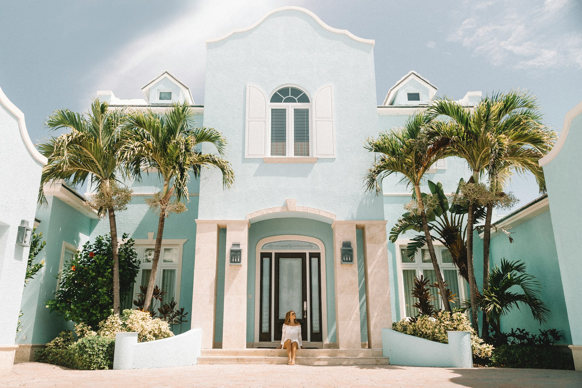 Person sitting on the front stairs of a house. Image by Unsplash