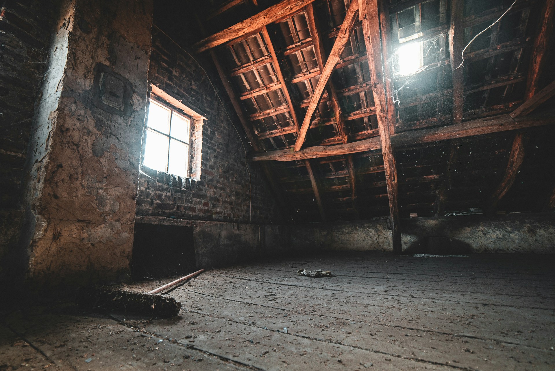 Empty, dirty attic during the day. Image by Unsplash.