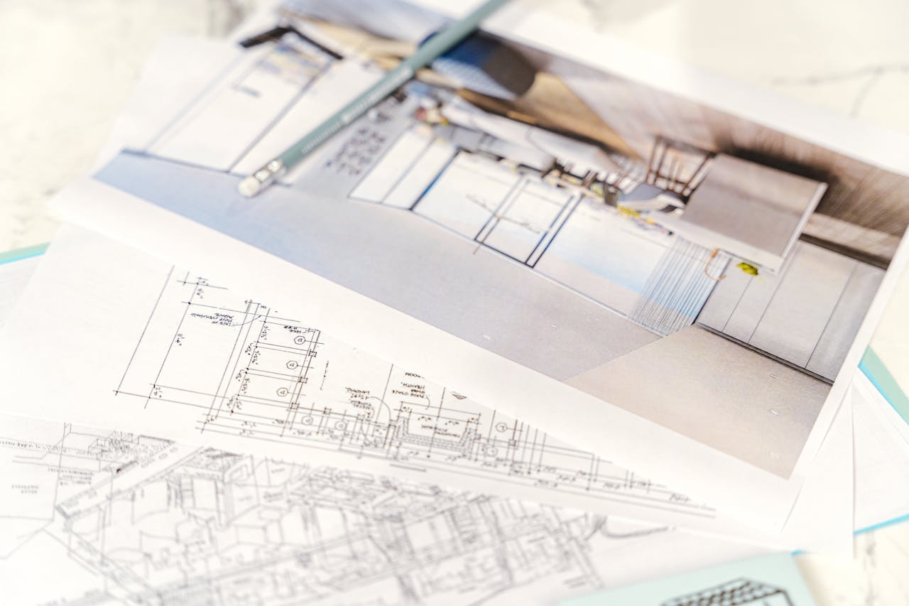 Floorplan and a picture on a table. Image by Pexels