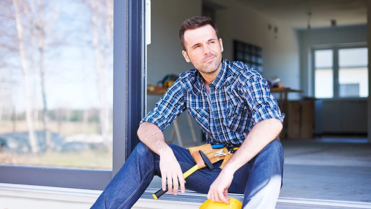 Contractor sitting in a door opening