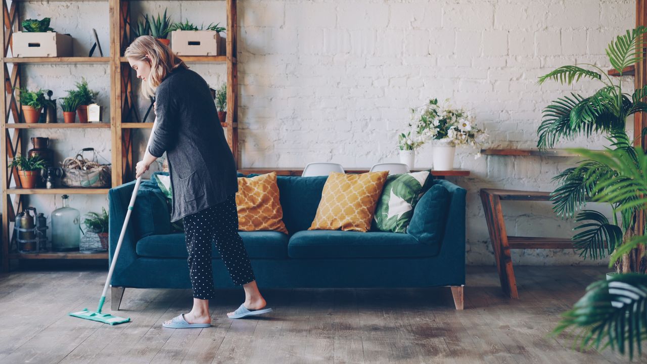 Cleaning a living room while preparing to sell a house. Image by Pexels