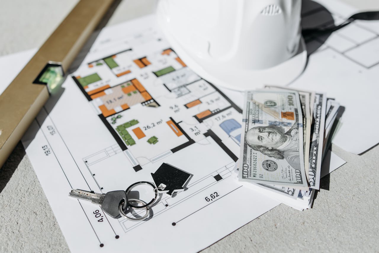 Money and keys lying on a paper with a house plan. Image by Pexels