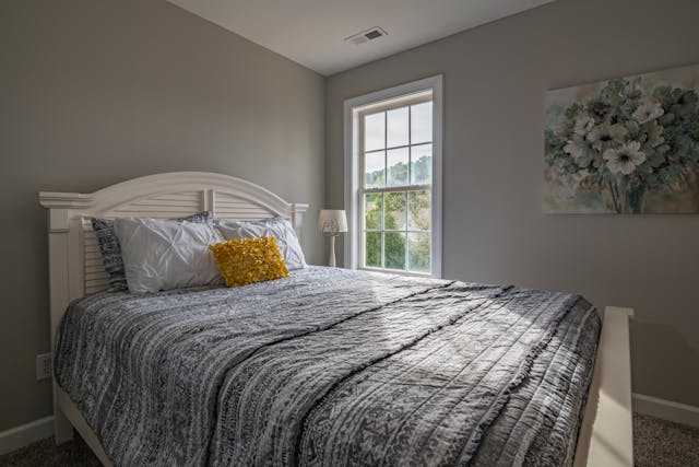 Bedroom, white and gray bed linen. Image by Pexels