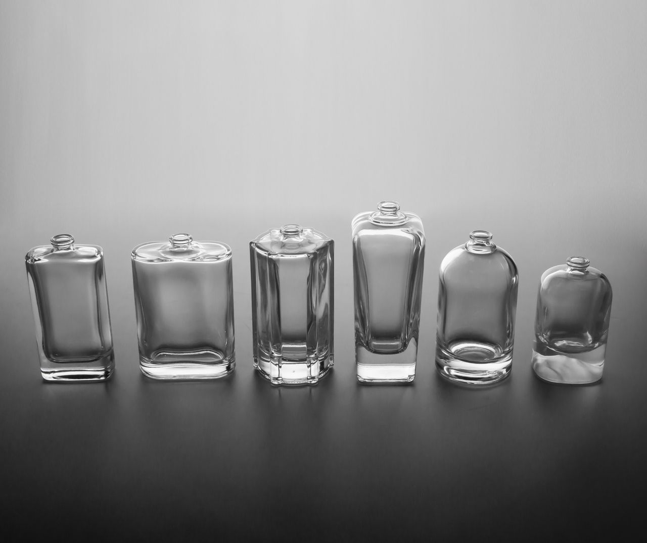 Premium glass cosmetic bottles in different sizes. Image by Pexels
