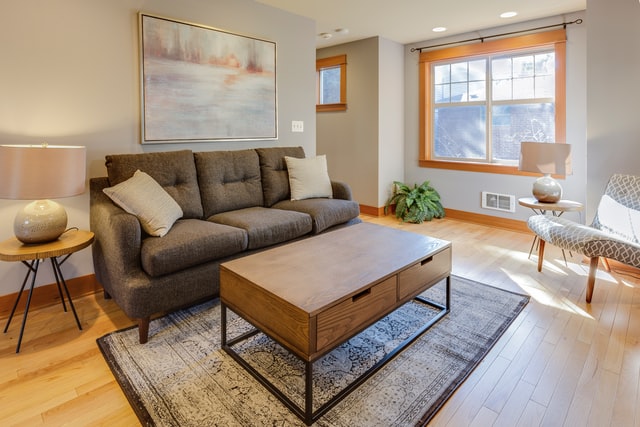 Livingroom, brown couch, wood table and side table, wall art