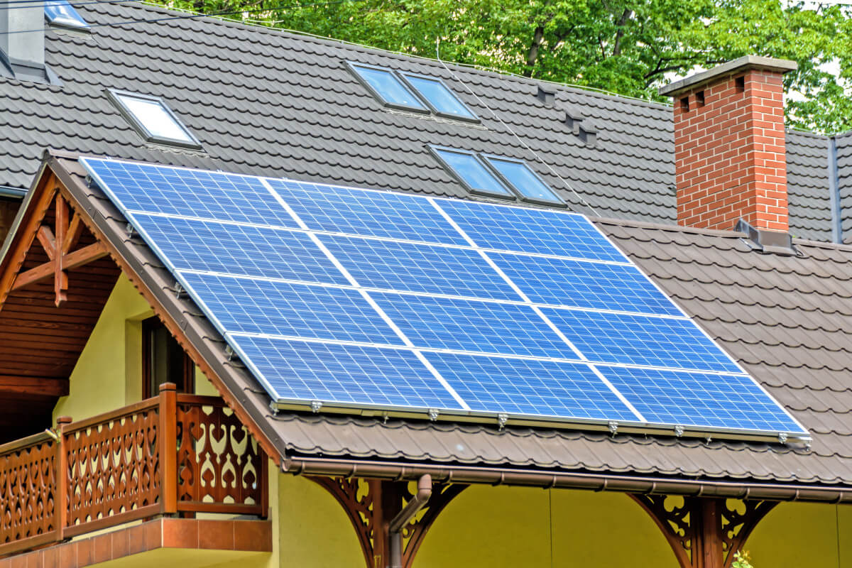 person installing solar panels on a roof