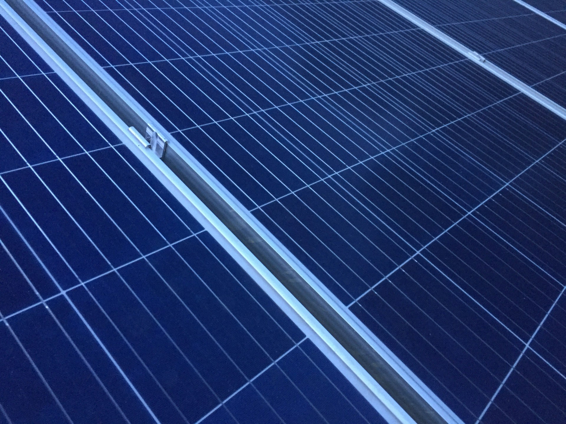 person installing solar panels on a roof