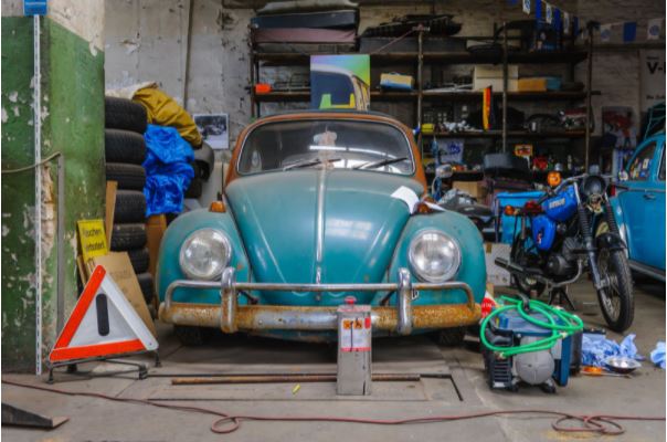 Garage with old car, tires, motorcycle, tools