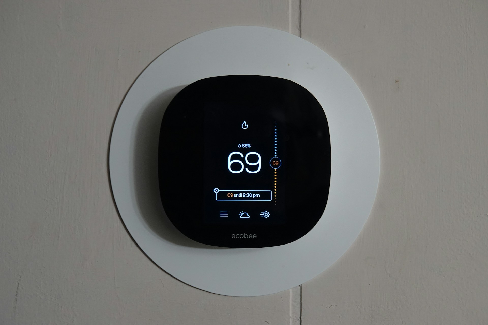 Smart thermostat showing a graphical user interface for managing rental property heating and cooling. Image via Unsplash