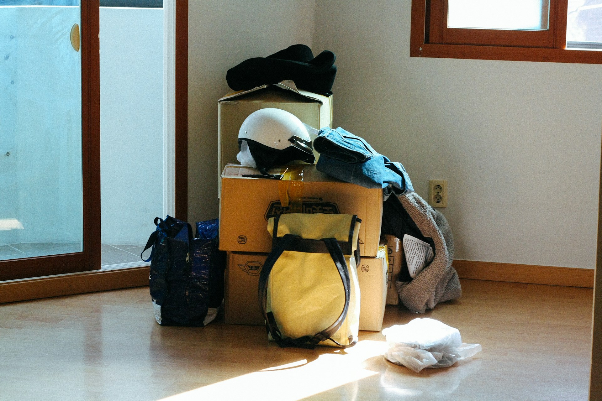 Boxes, bags, helmet on floor