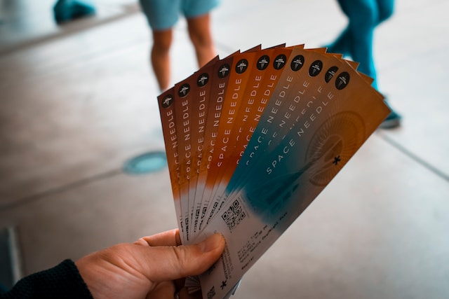 person holding 11 tickets in their hand