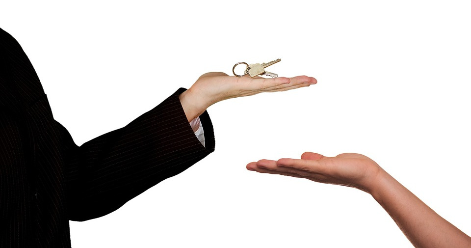 Person handing over keys to someone else