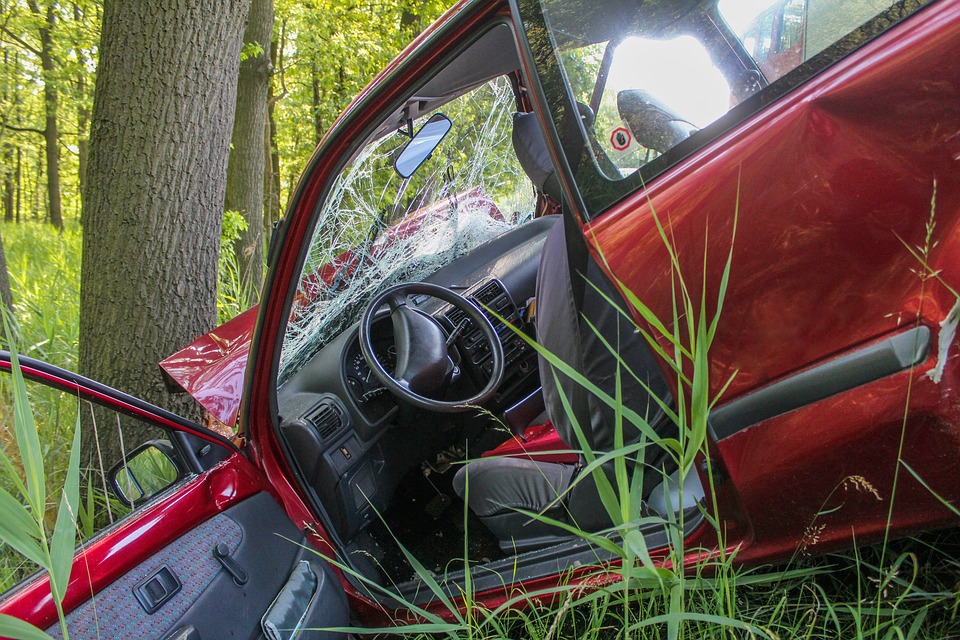 Red car has driven in to a tree, accident