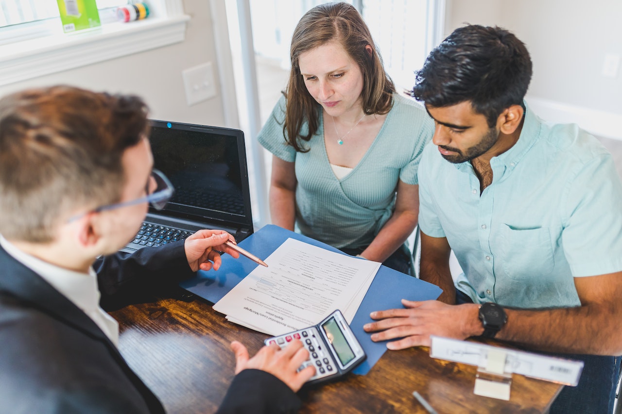 mortgage broker explaining paperwork to a couple
